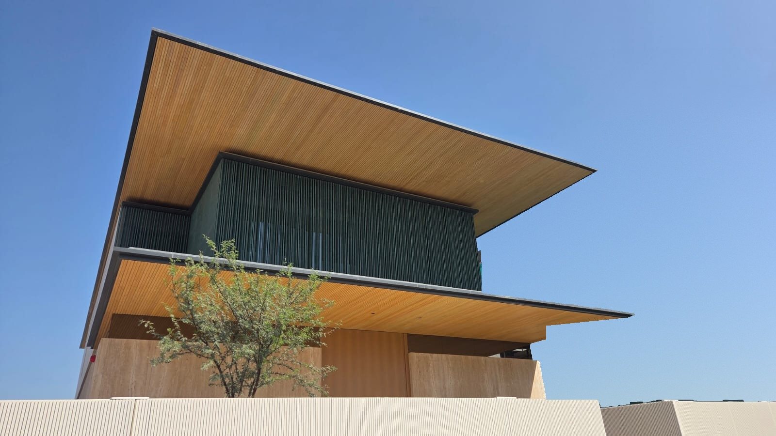 MV02, Jumeirah Bay Island, timber look soffits under a clear sky