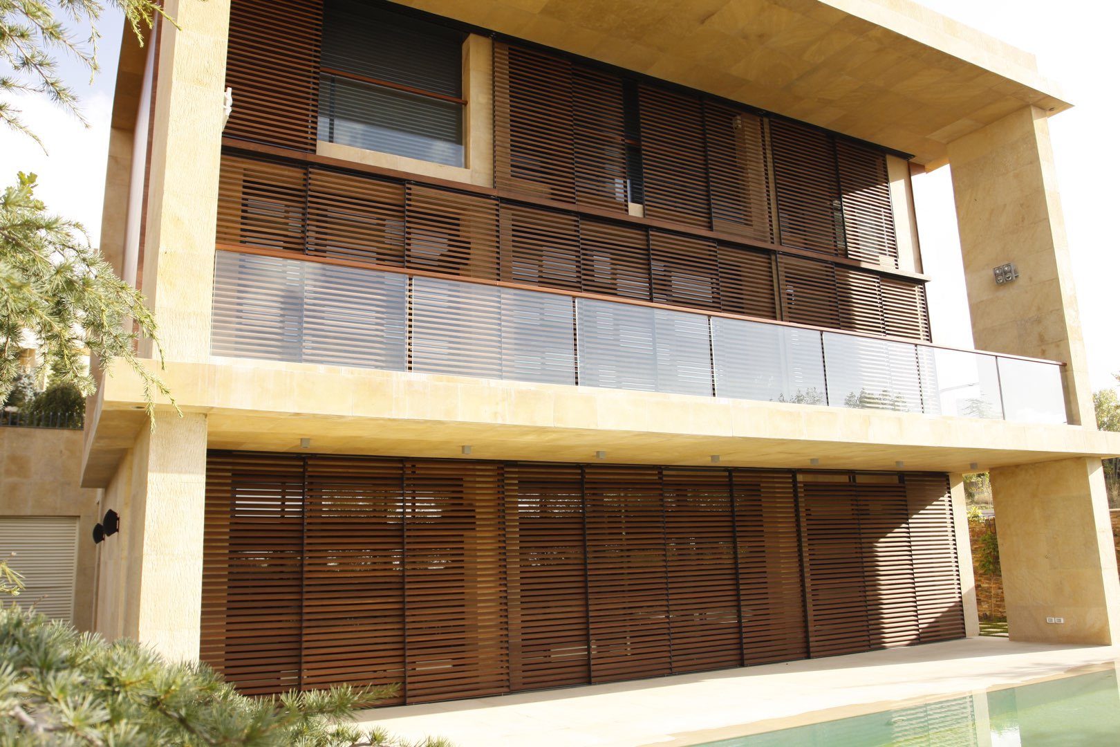 Sliding timber shutters on a villa