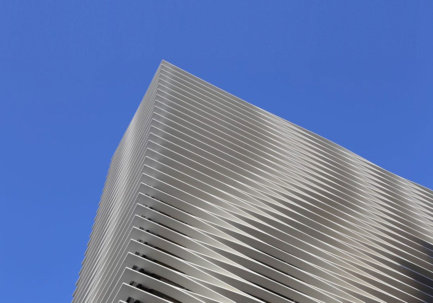Aluminium louvres wrapping a building corner